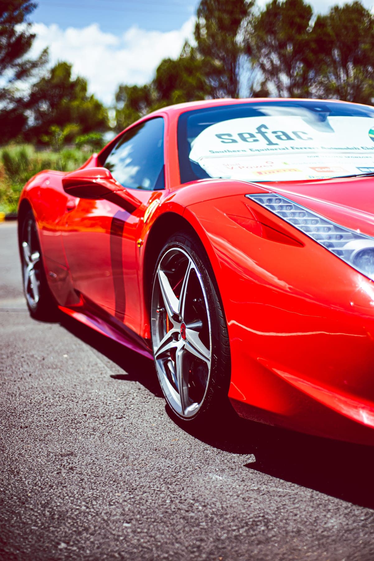 Red Ferrari 458 front quarter in the sun