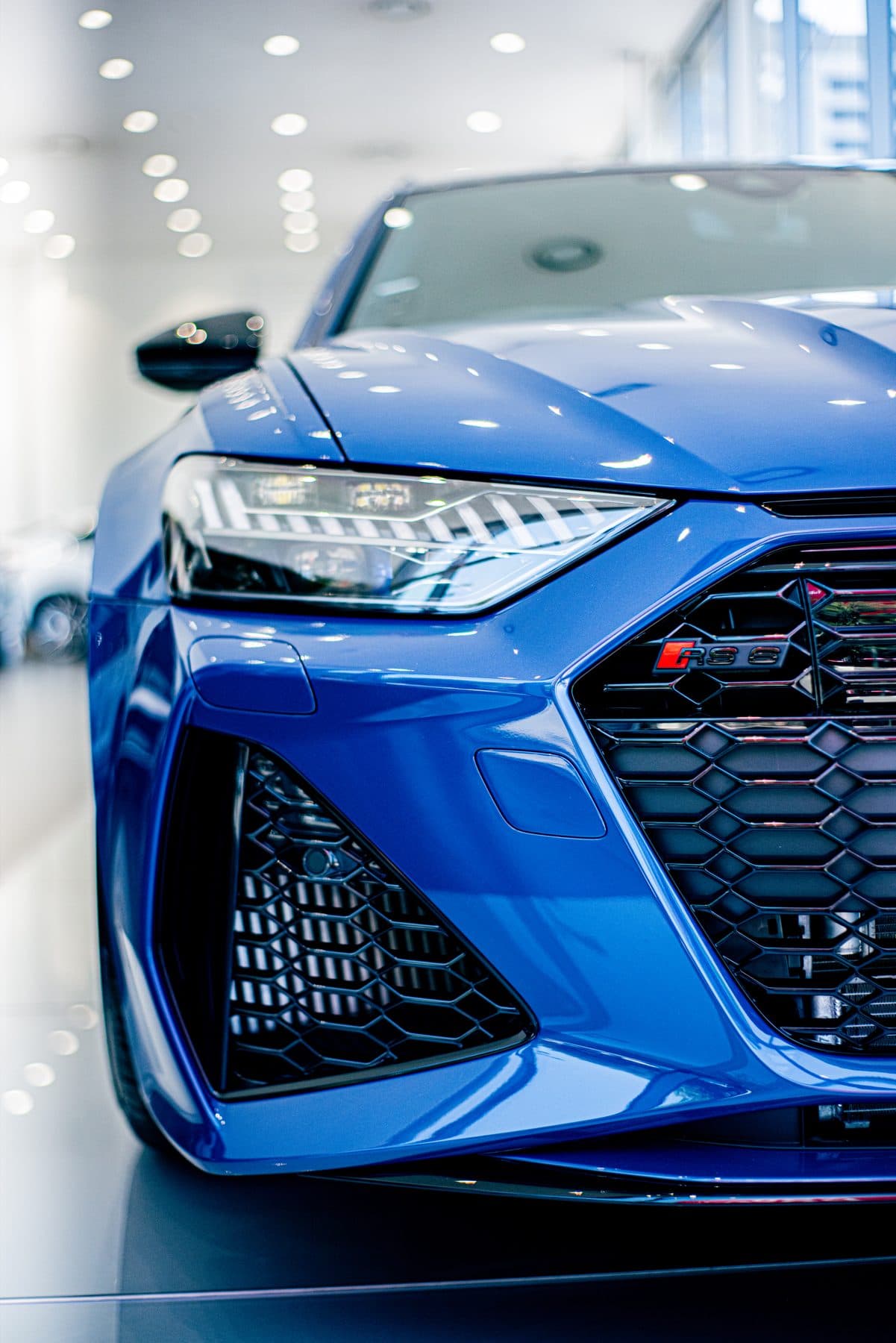 Blue Audi RS front end in a showroom