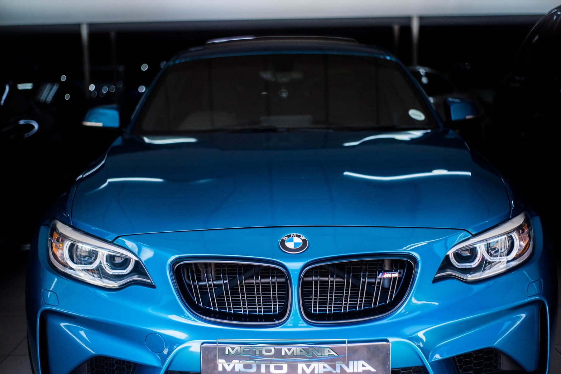 Long Beach blue BMW M2 front in the showroom