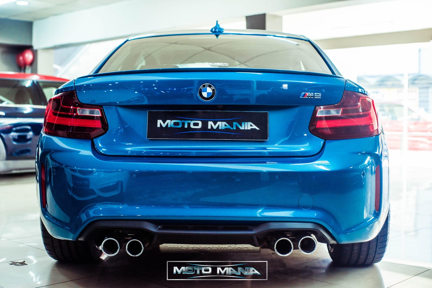 Blue BMW M2 rear and quad pipes