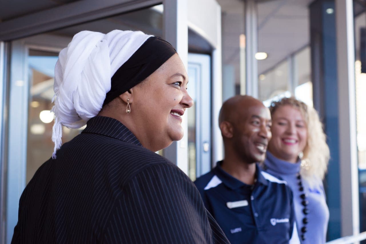Guests smiling at the doors of a new Standard Bank branch