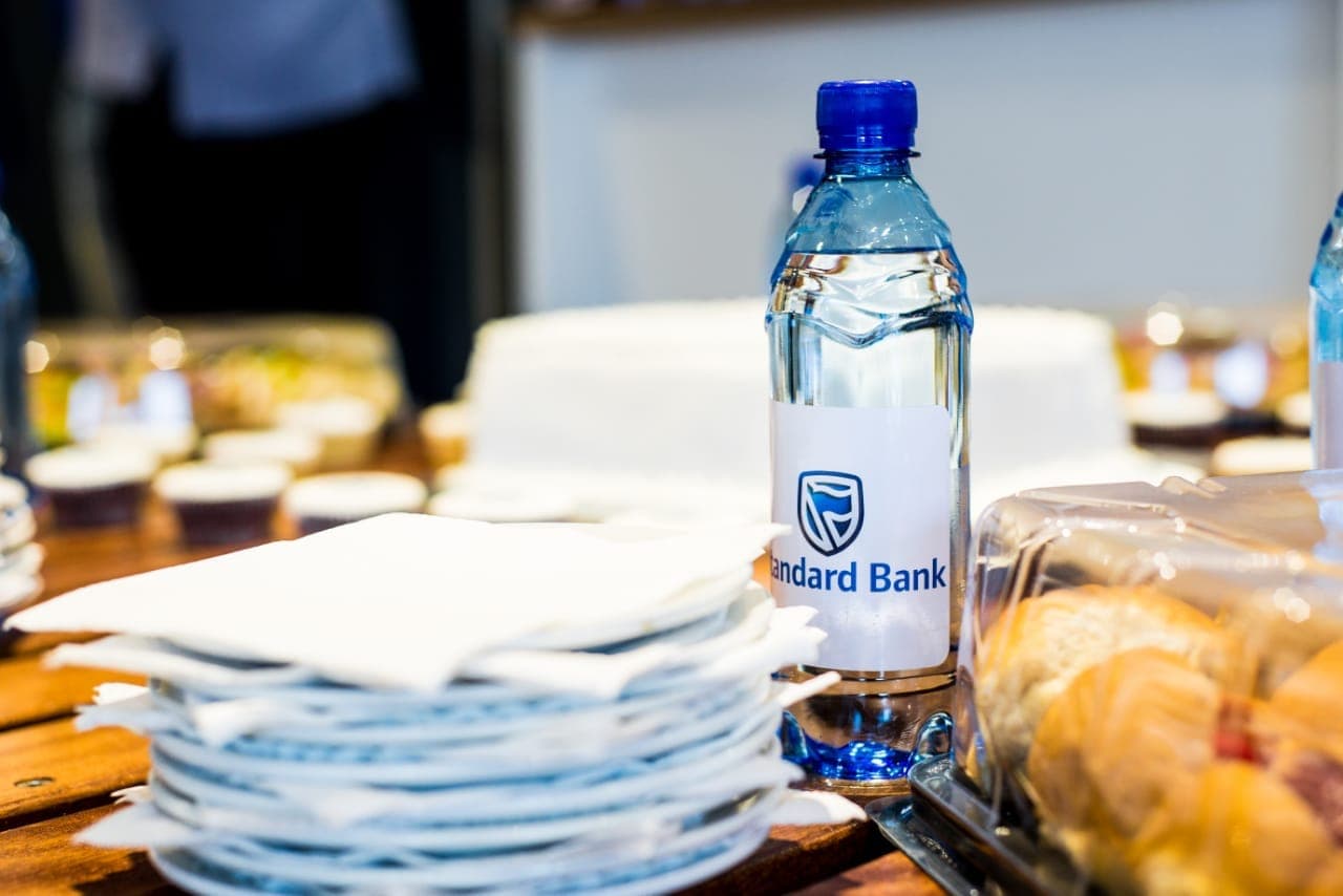 Standard Bank branded water and cakes laid out for a branch launch