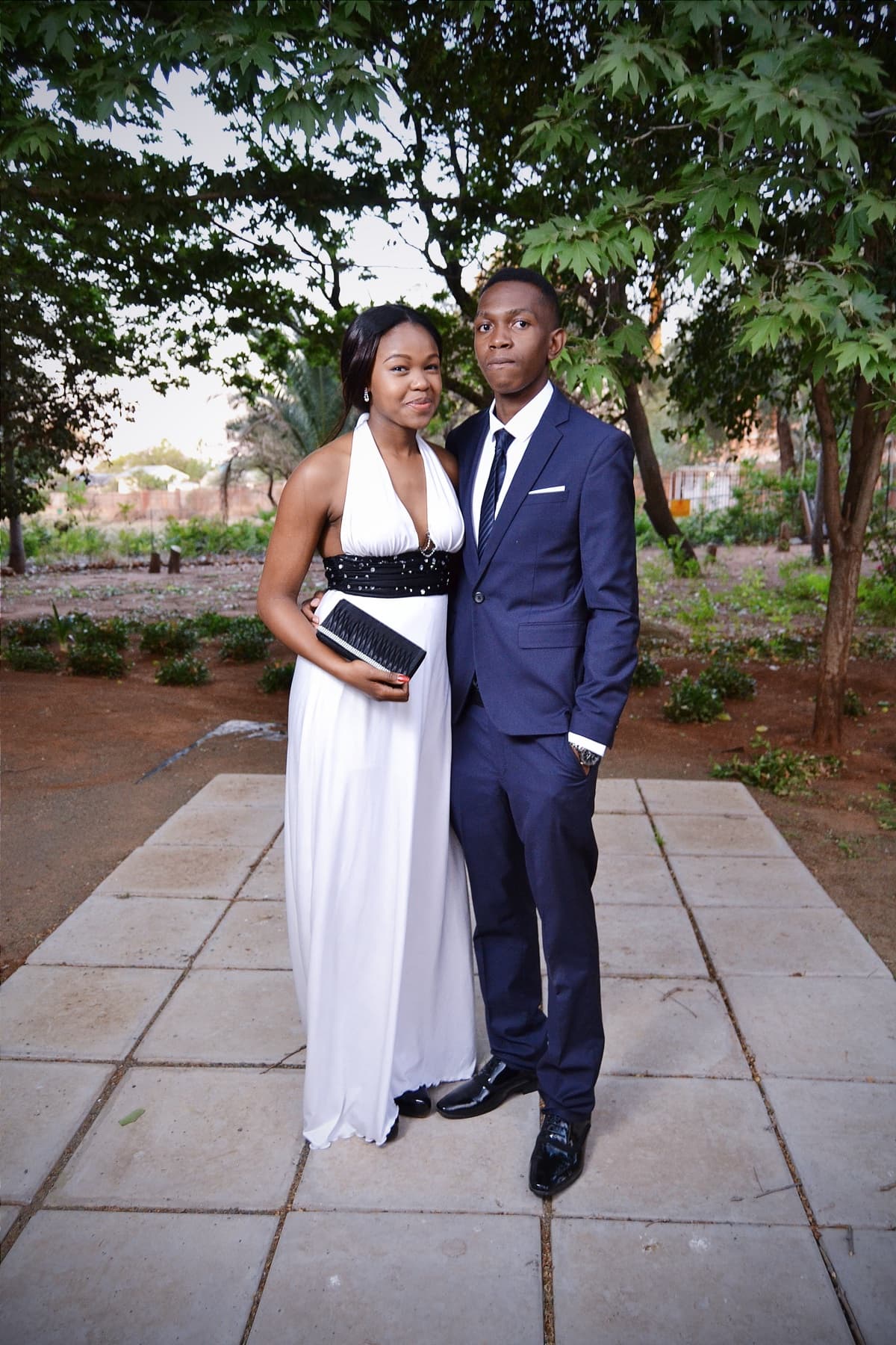 Matric dance couple on the garden path