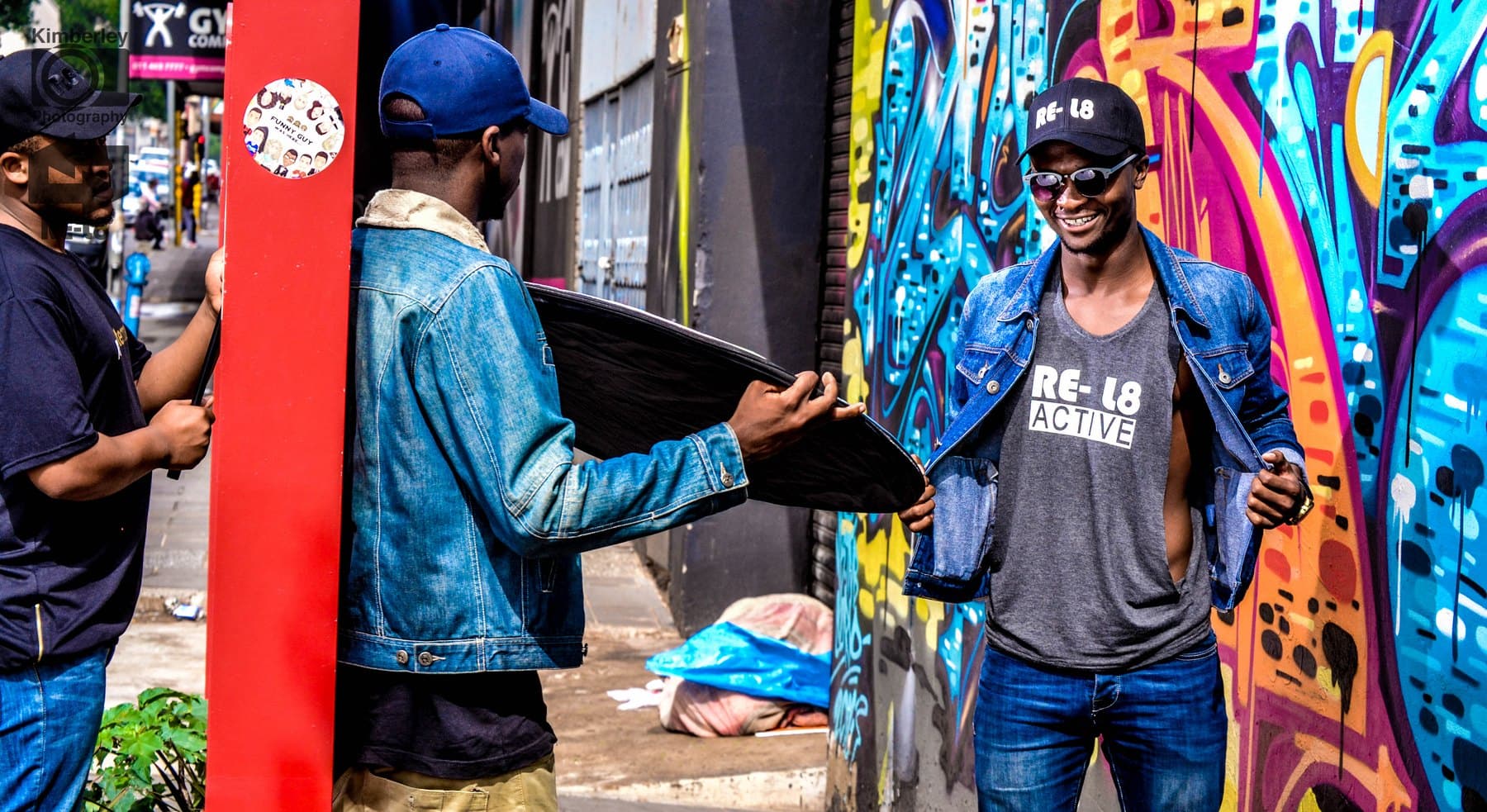RE-L8 Active shoot against a graffiti wall, reflector in hand