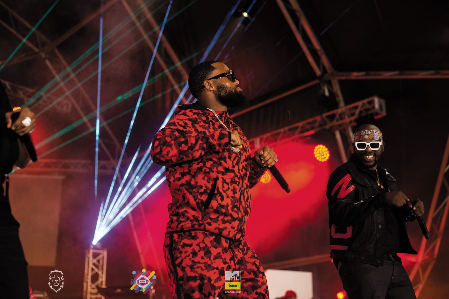 Cassper Nyovest mid-verse in front of red lights and white lasers
