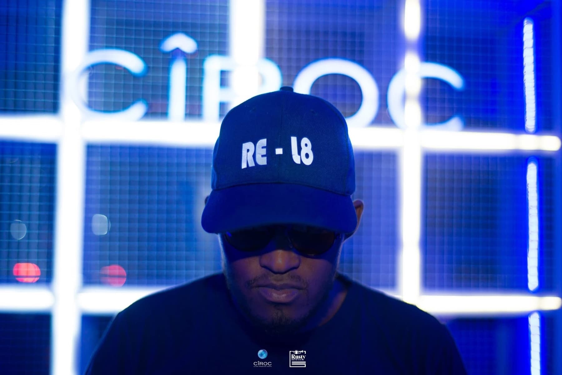 Cap bowed under the CÎROC sign, blue bars behind