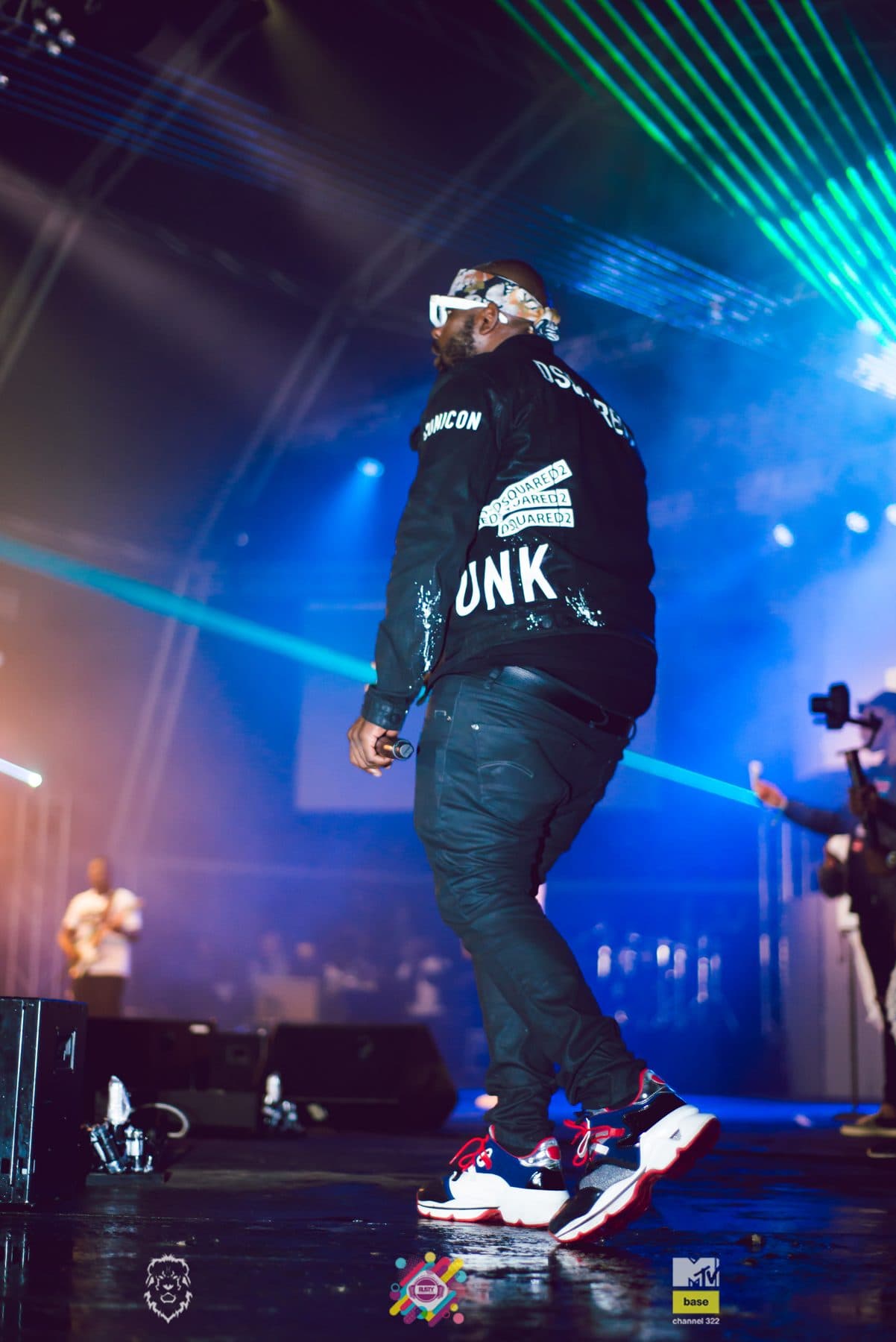 Rapper mid-verse under blue lasers