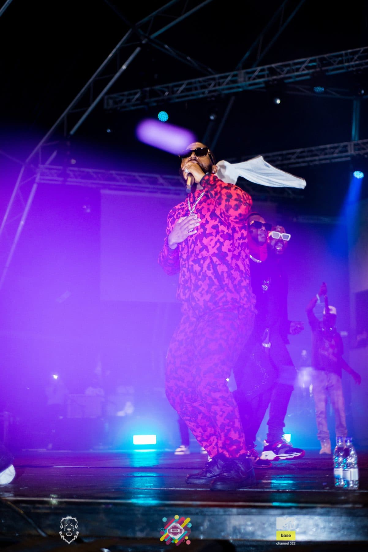 Performer in a purple wash on a festival stage