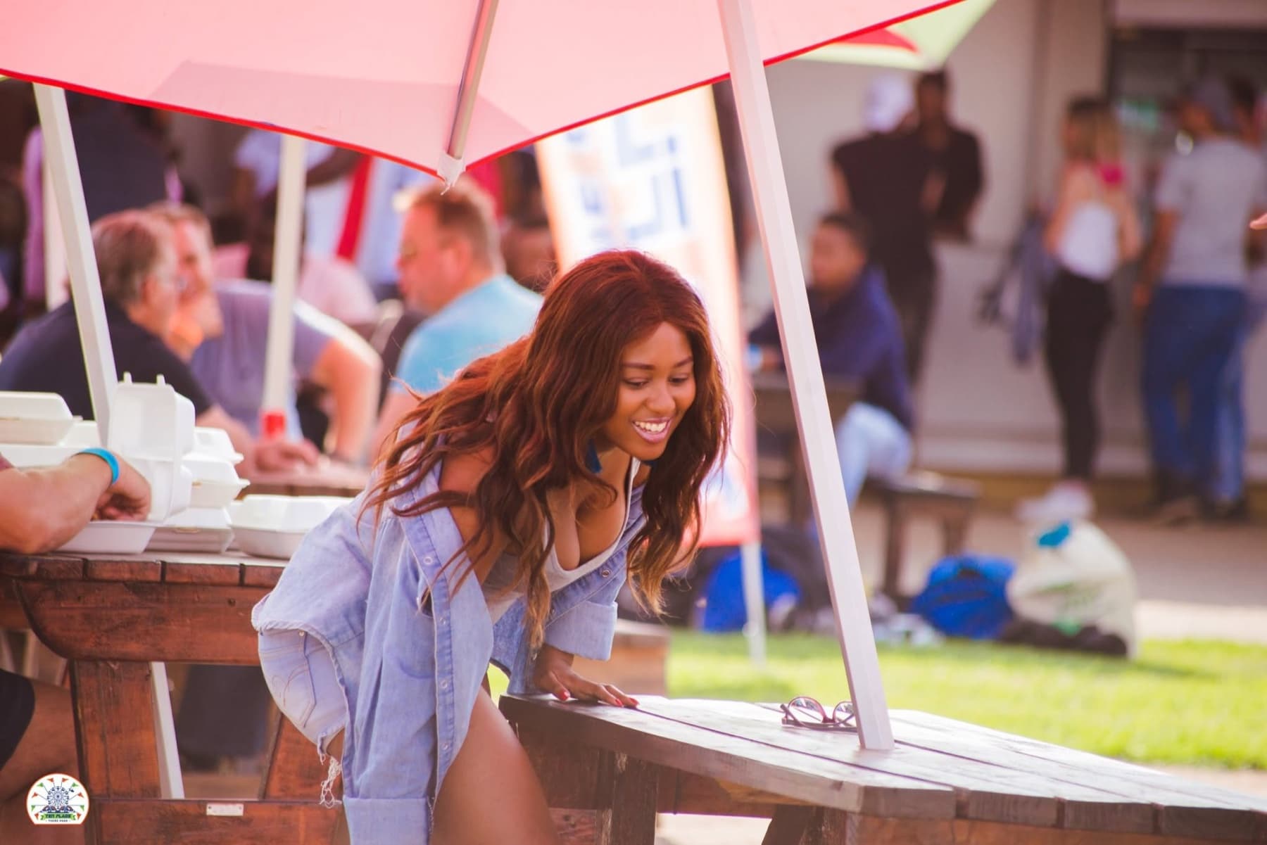 Taking a friend's photo across a picnic table