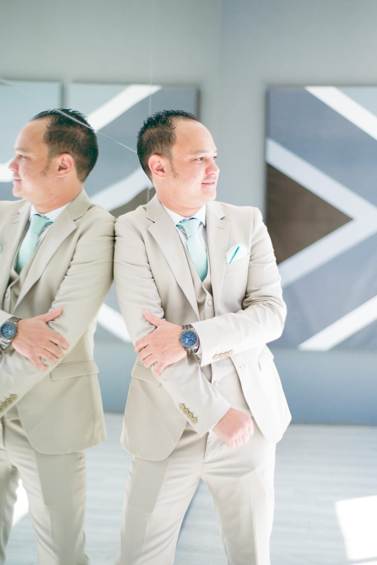 Groomsmen in beige suits checking their watches