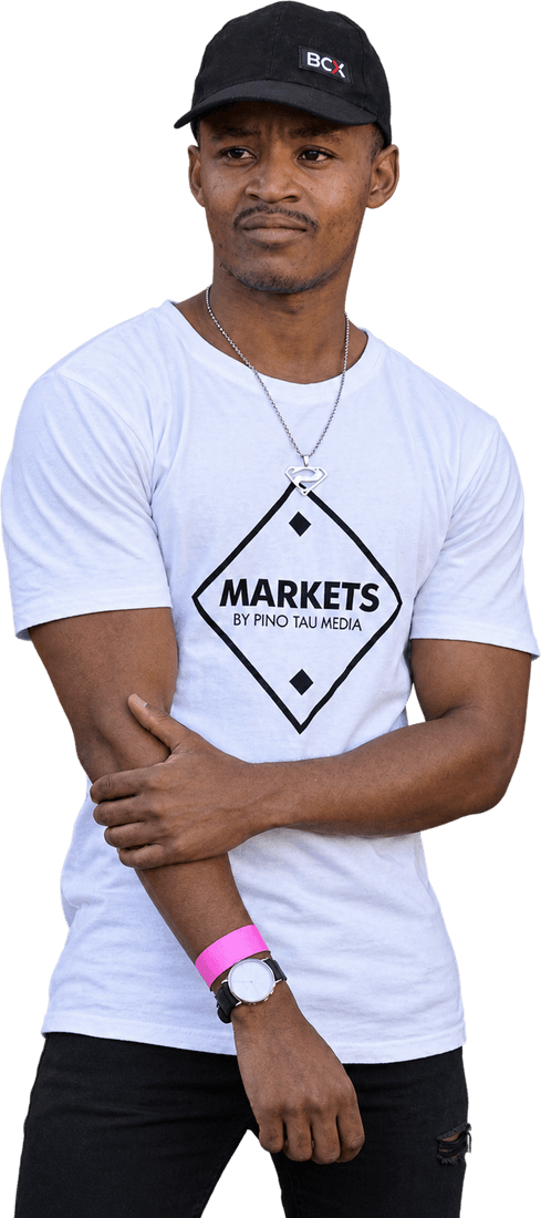 Sazi Ndlovu as a young photographer, in a cap and a Markets by Pino Tau Media tee, arms folded
