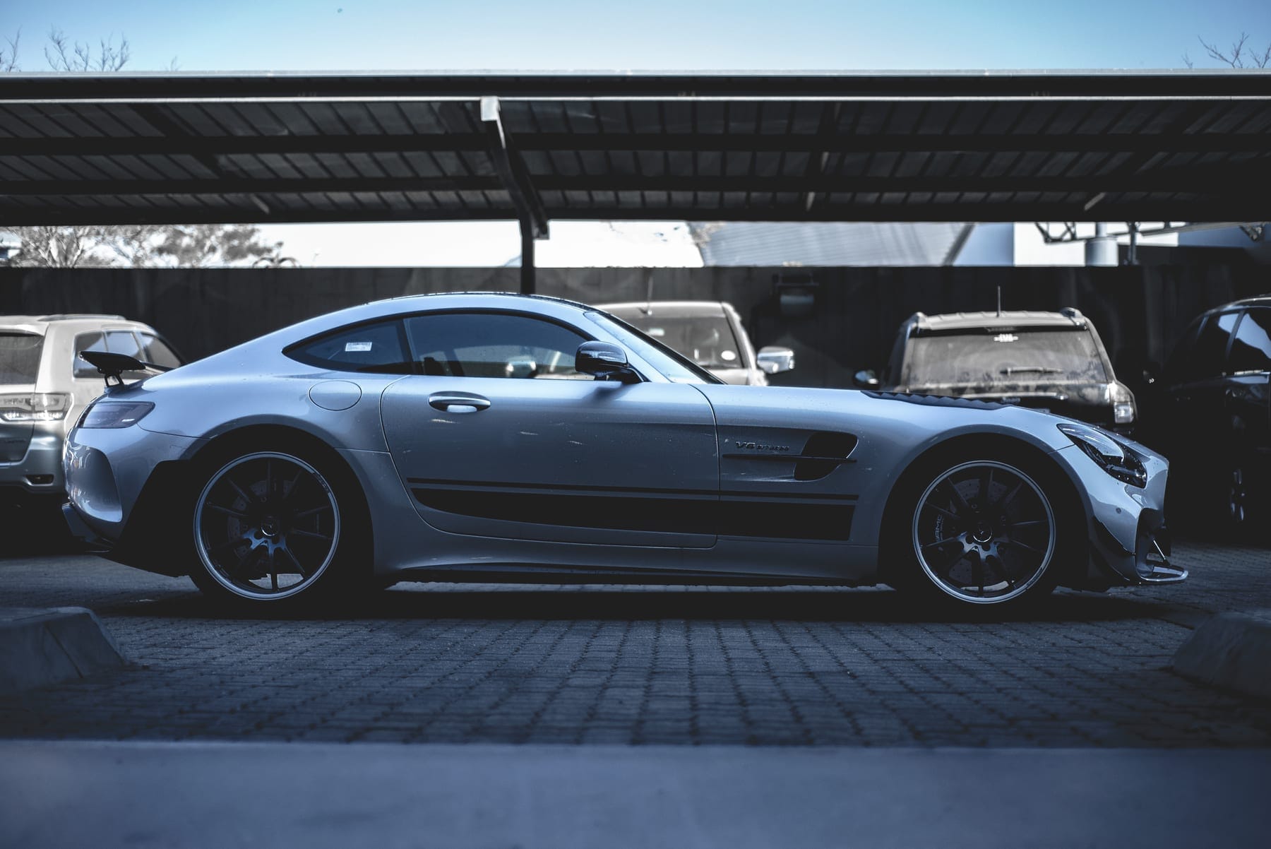 Grey Mercedes-AMG GT side-on under a carport