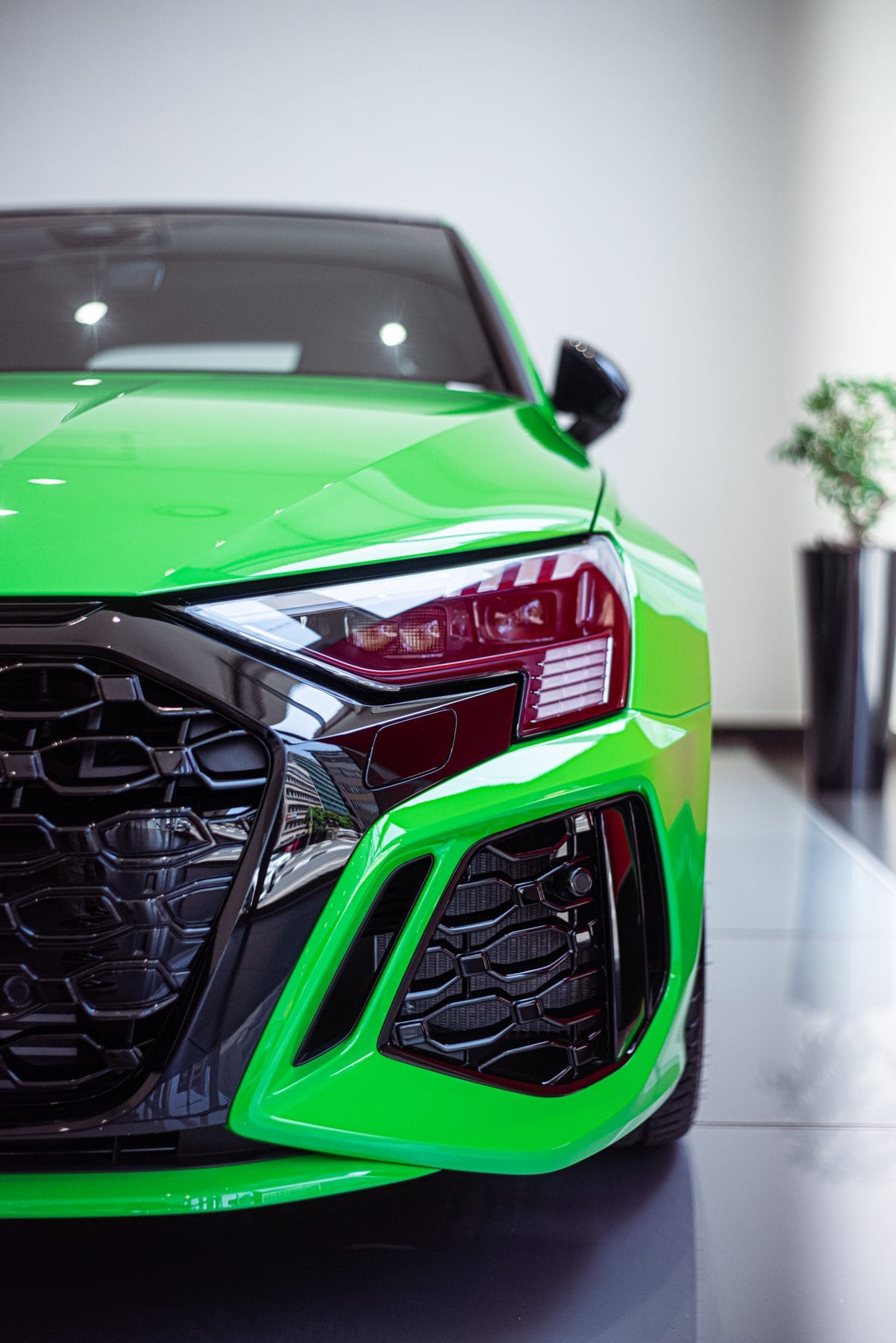 Bright green Audi RS3 in a showroom