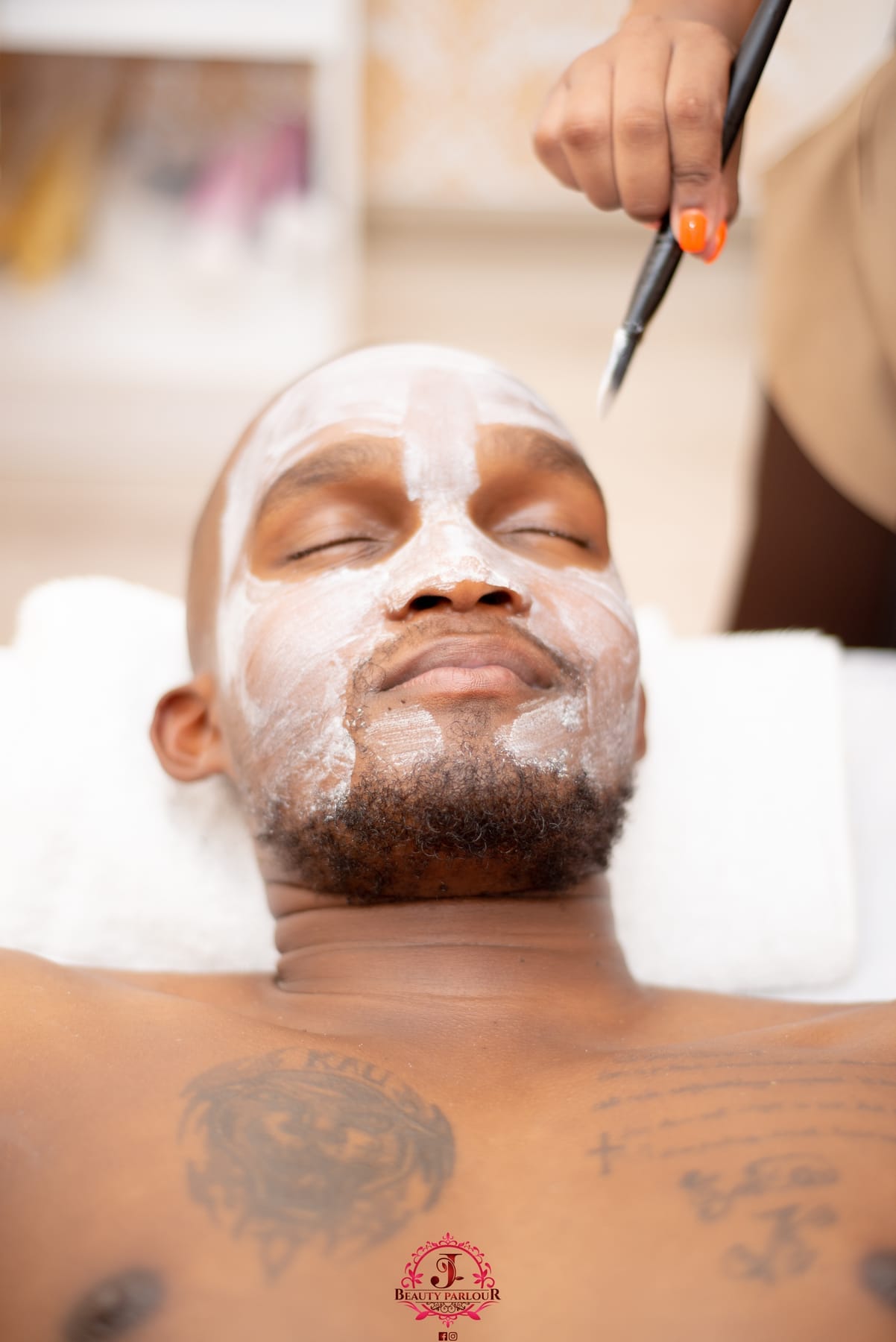 Man relaxing with a white facial mask on