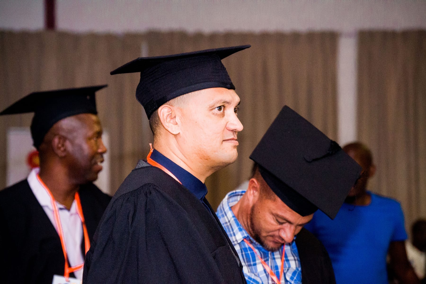 Graduates settling their caps before the ceremony