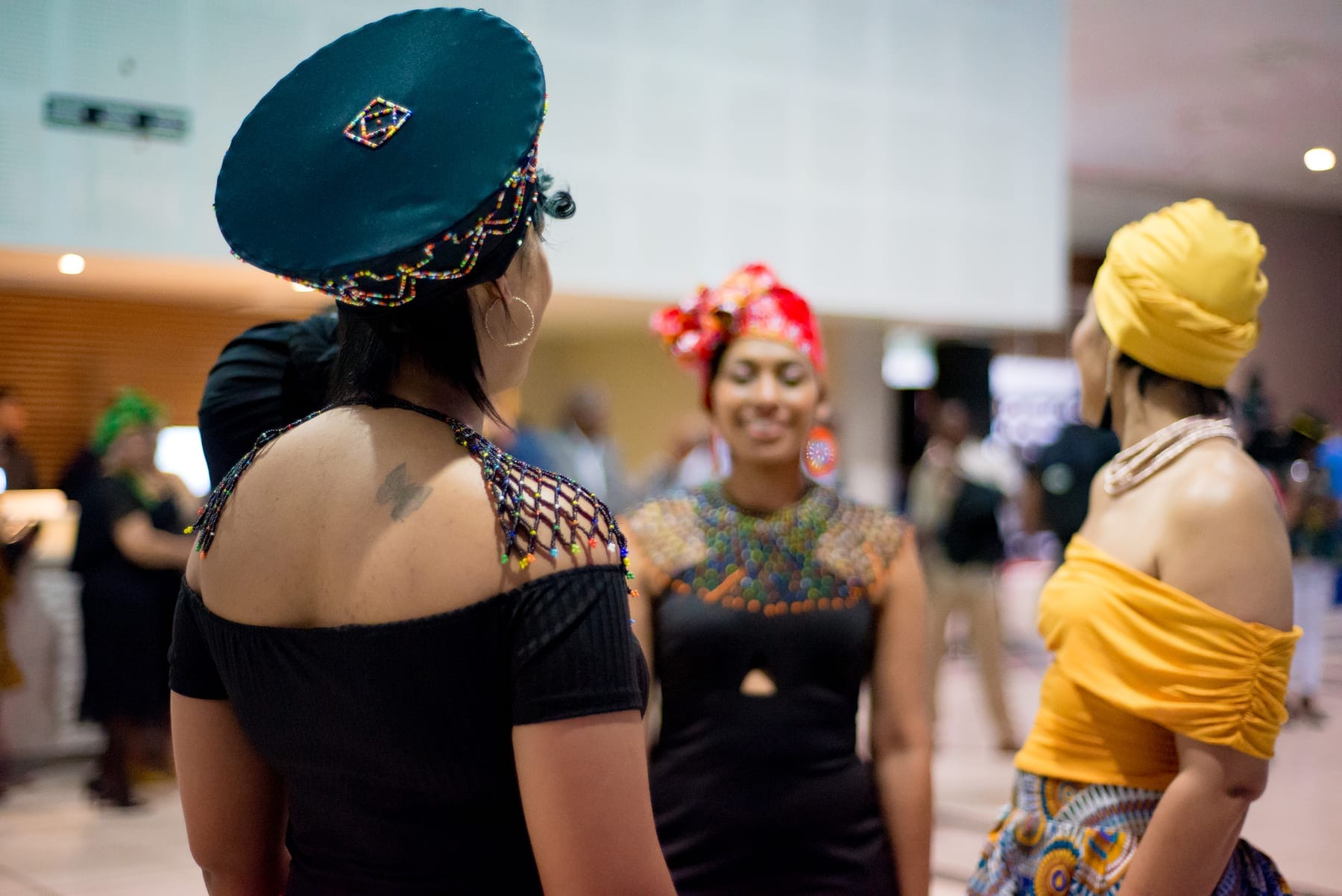 Guests in headwraps and lace at an evening event