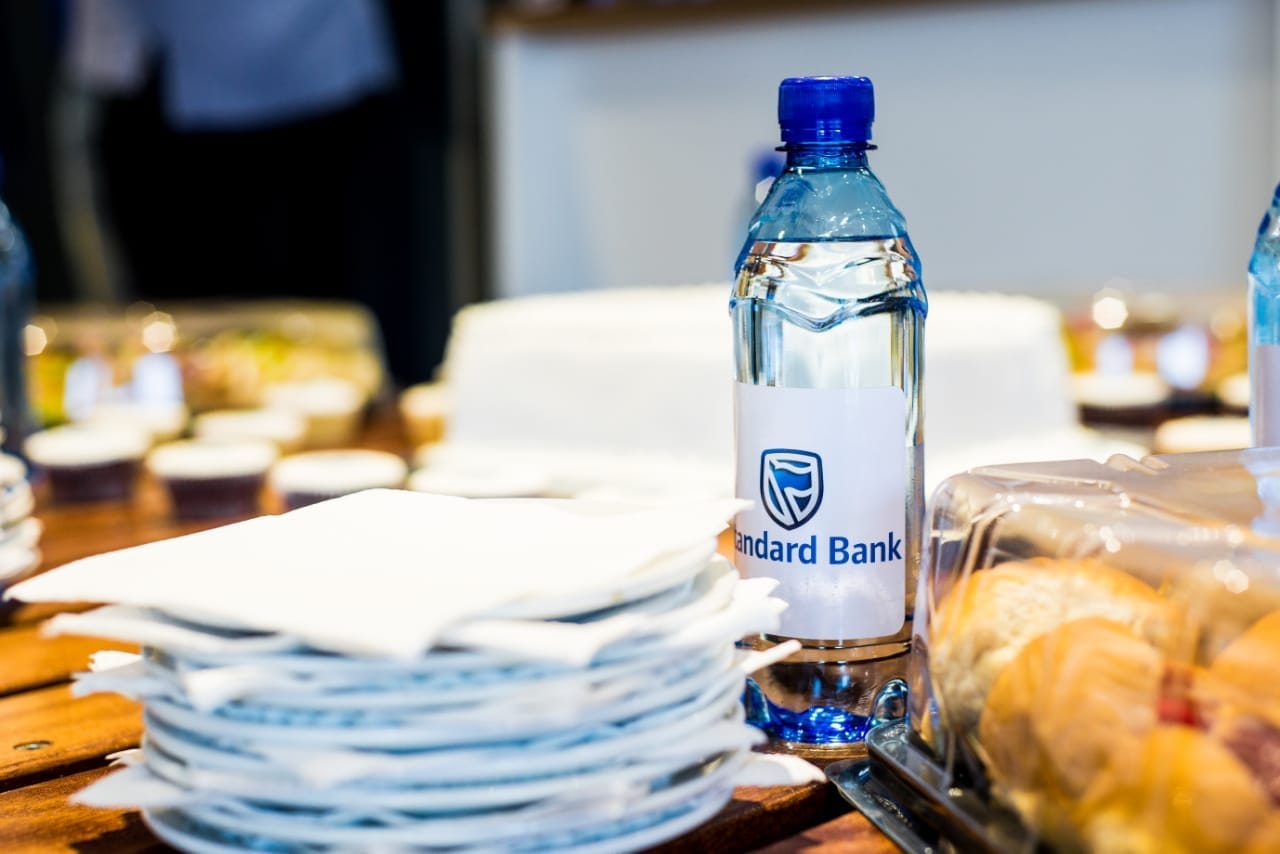 Standard Bank branded water and cakes laid out for a branch launch
