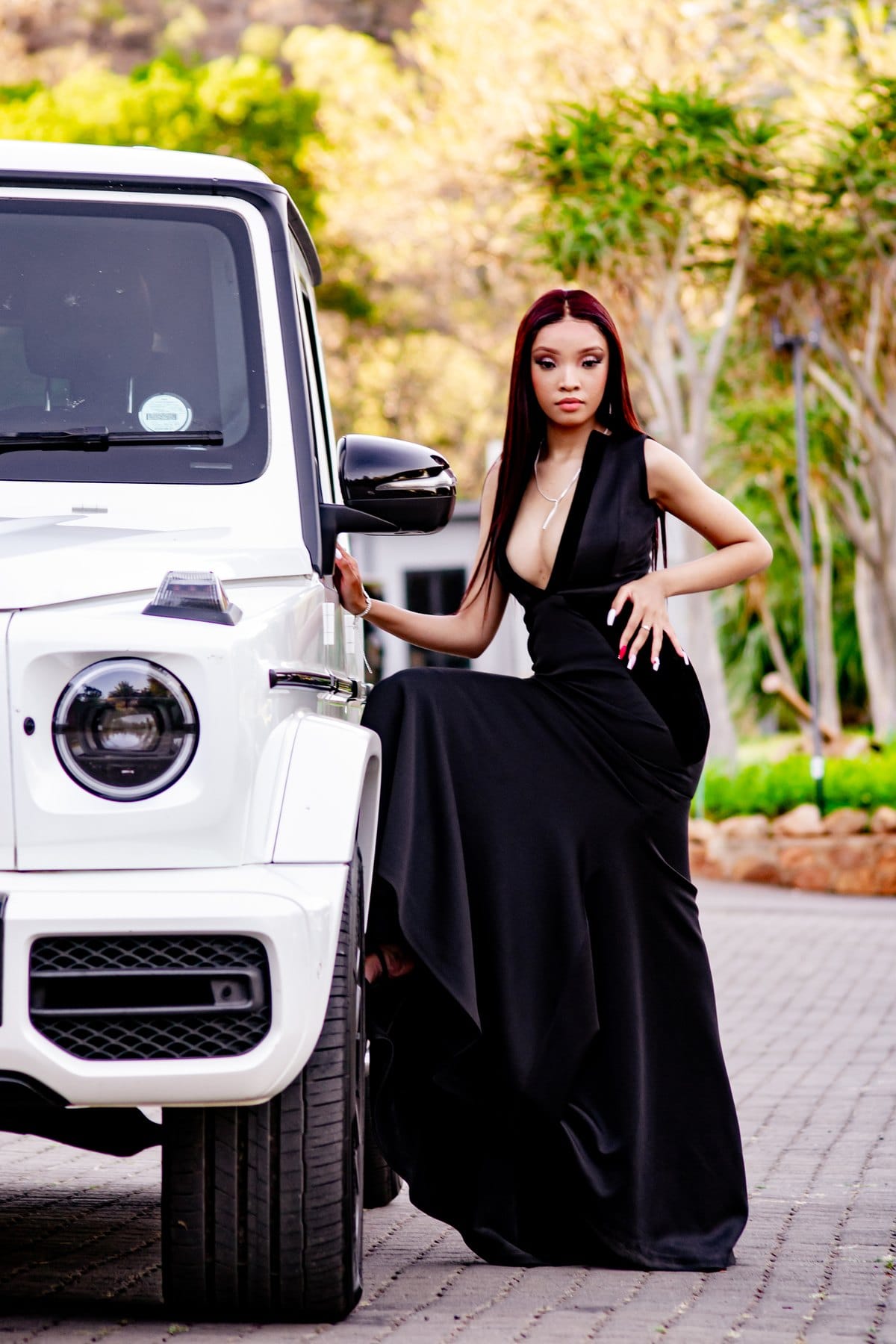 Black gown beside a white G-Wagon
