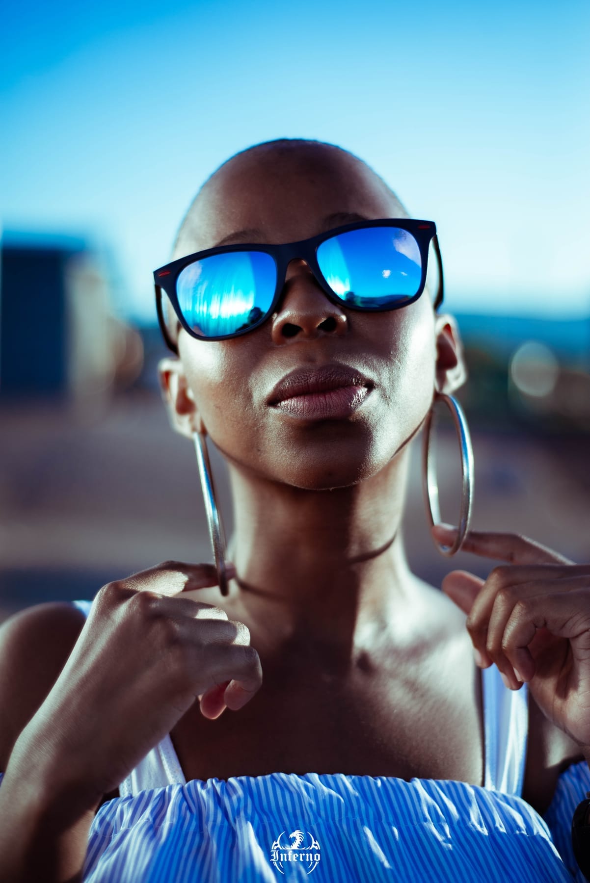 Close portrait in blue mirrored sunglasses