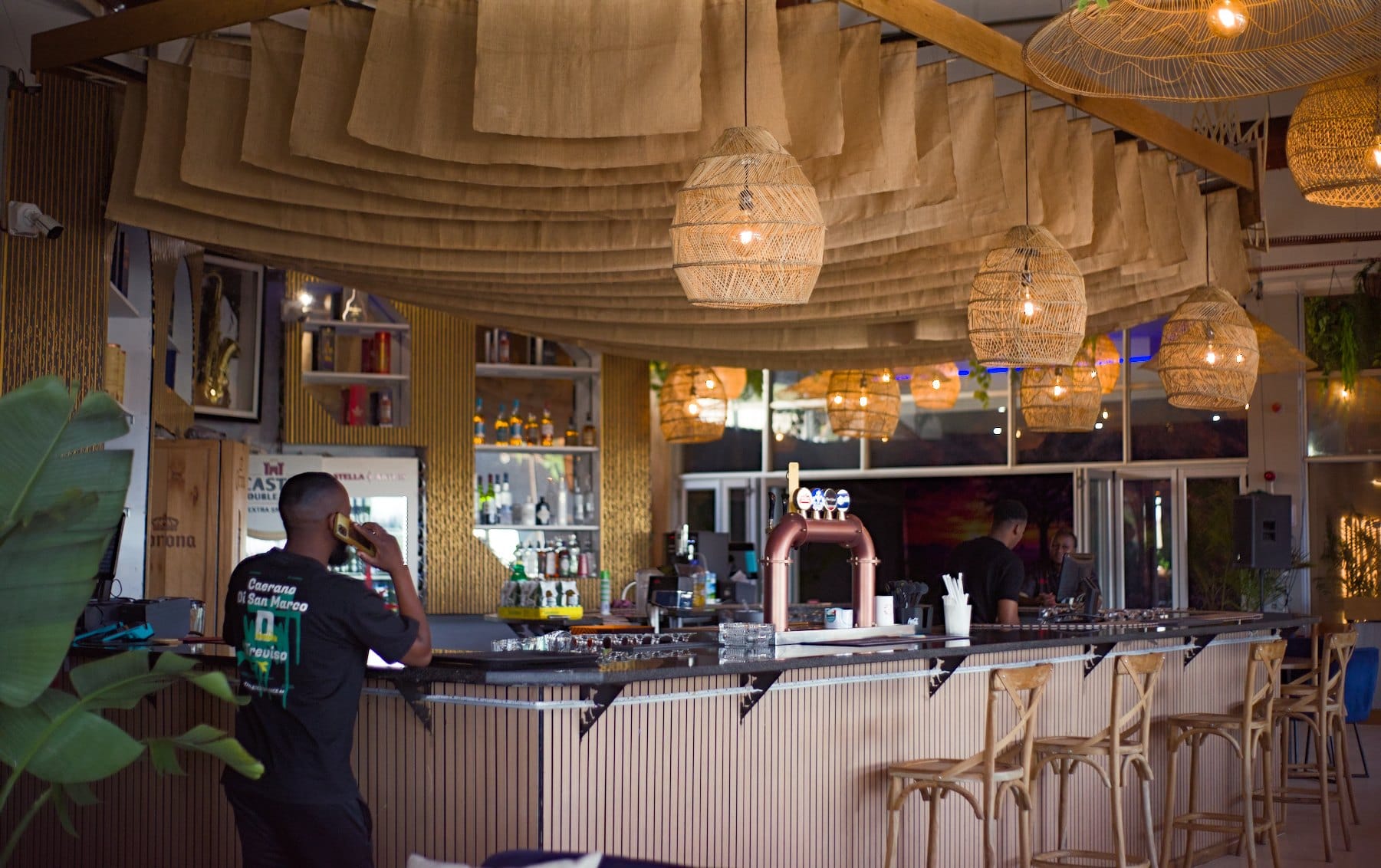Rattan lanterns and hessian canopies over a cafe bar