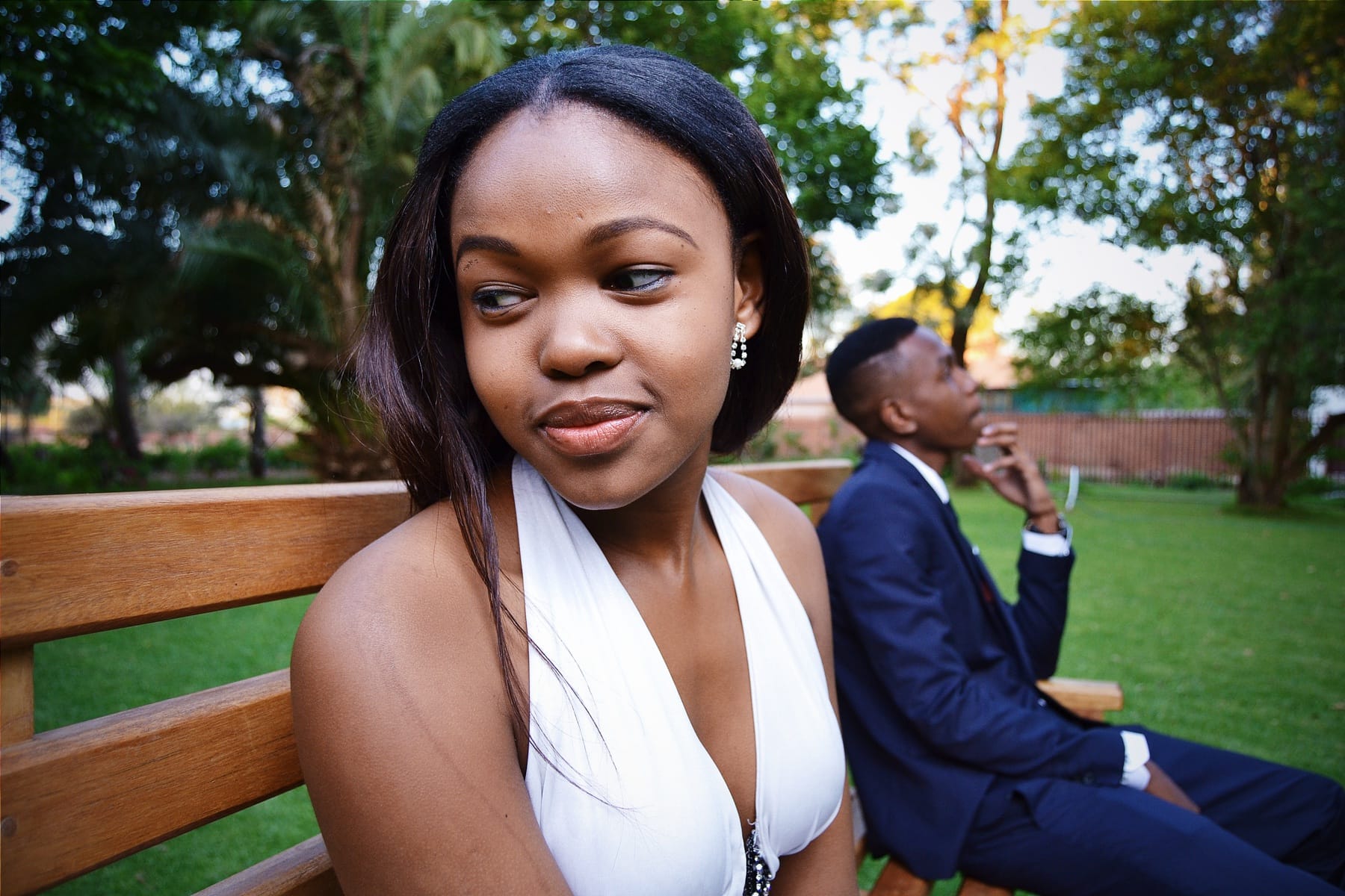 Matric dance, her glance over the bench, him behind