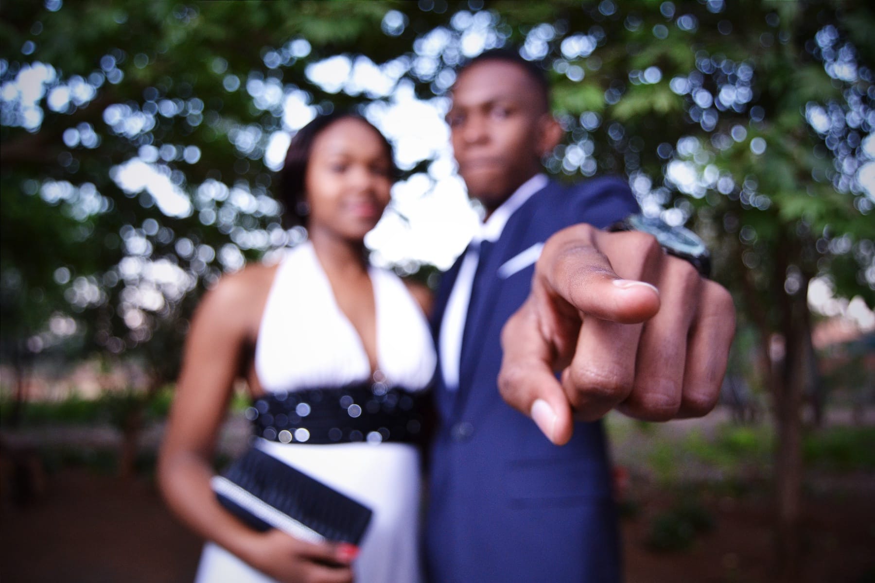 Matric dance couple, his finger pointing at the lens