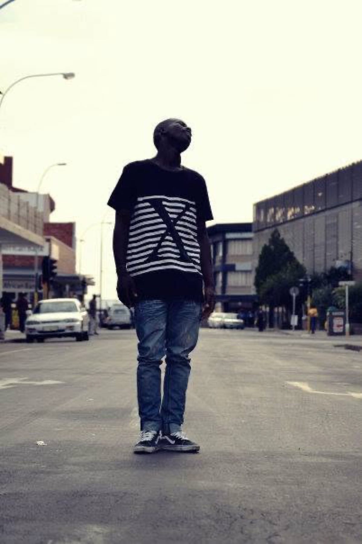 Striped X tee in the middle of a city street, looking up