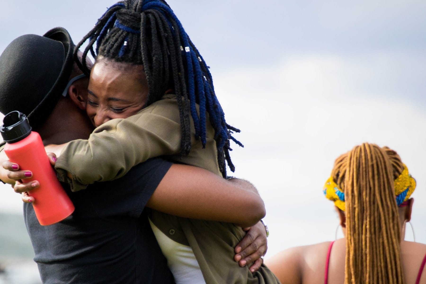 Friends embracing in a festival field
