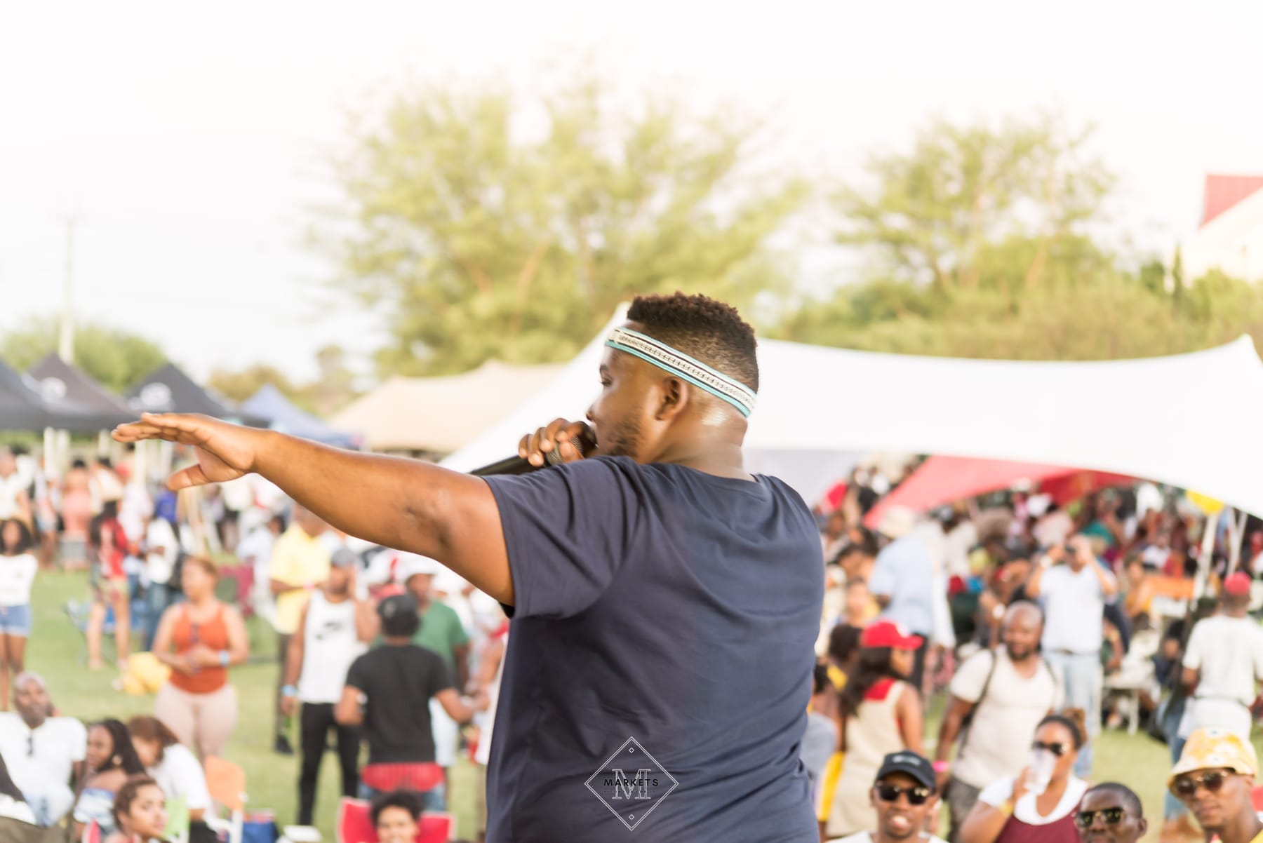 MC pointing out over a daytime festival crowd