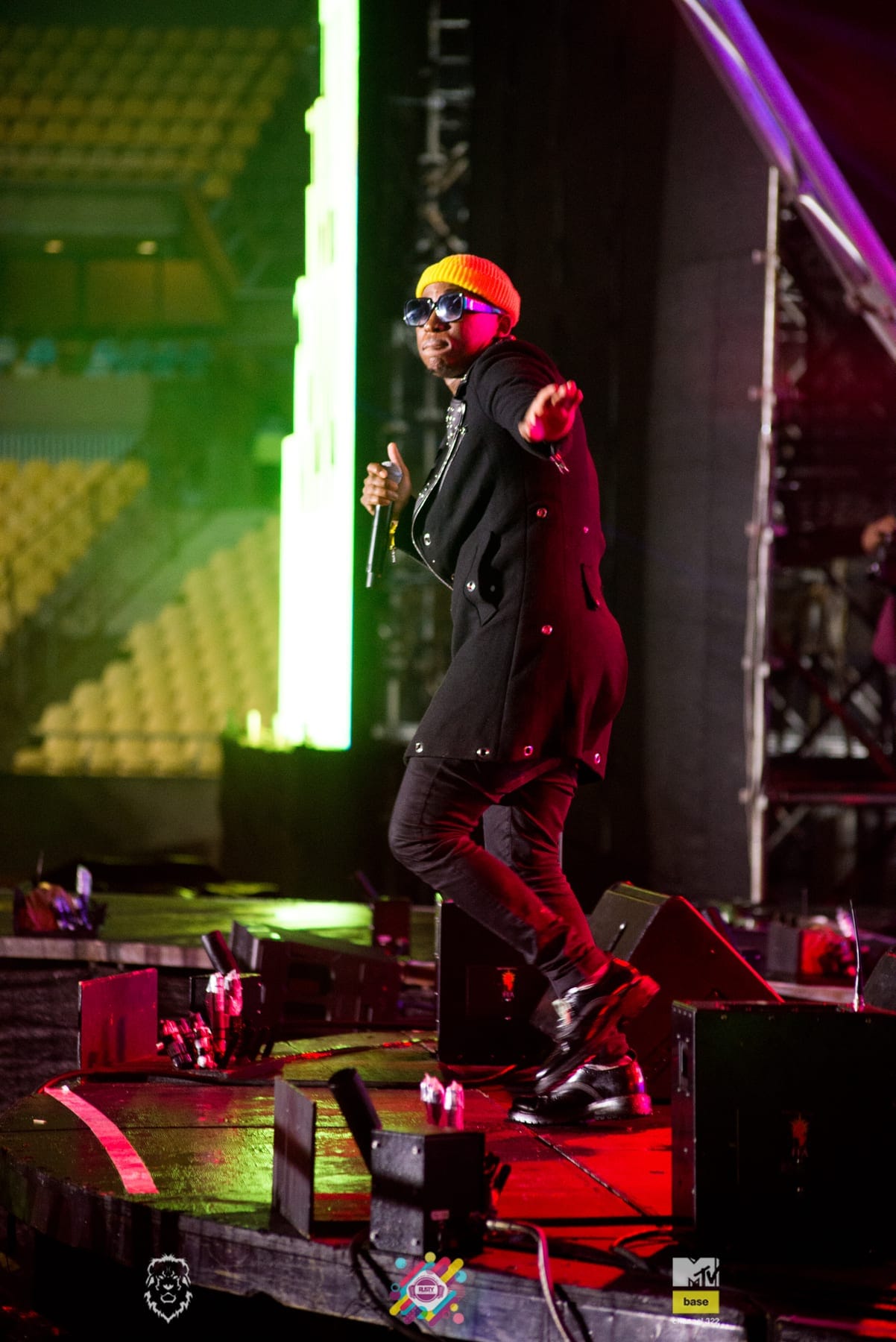 Rapper in red light striding the stage