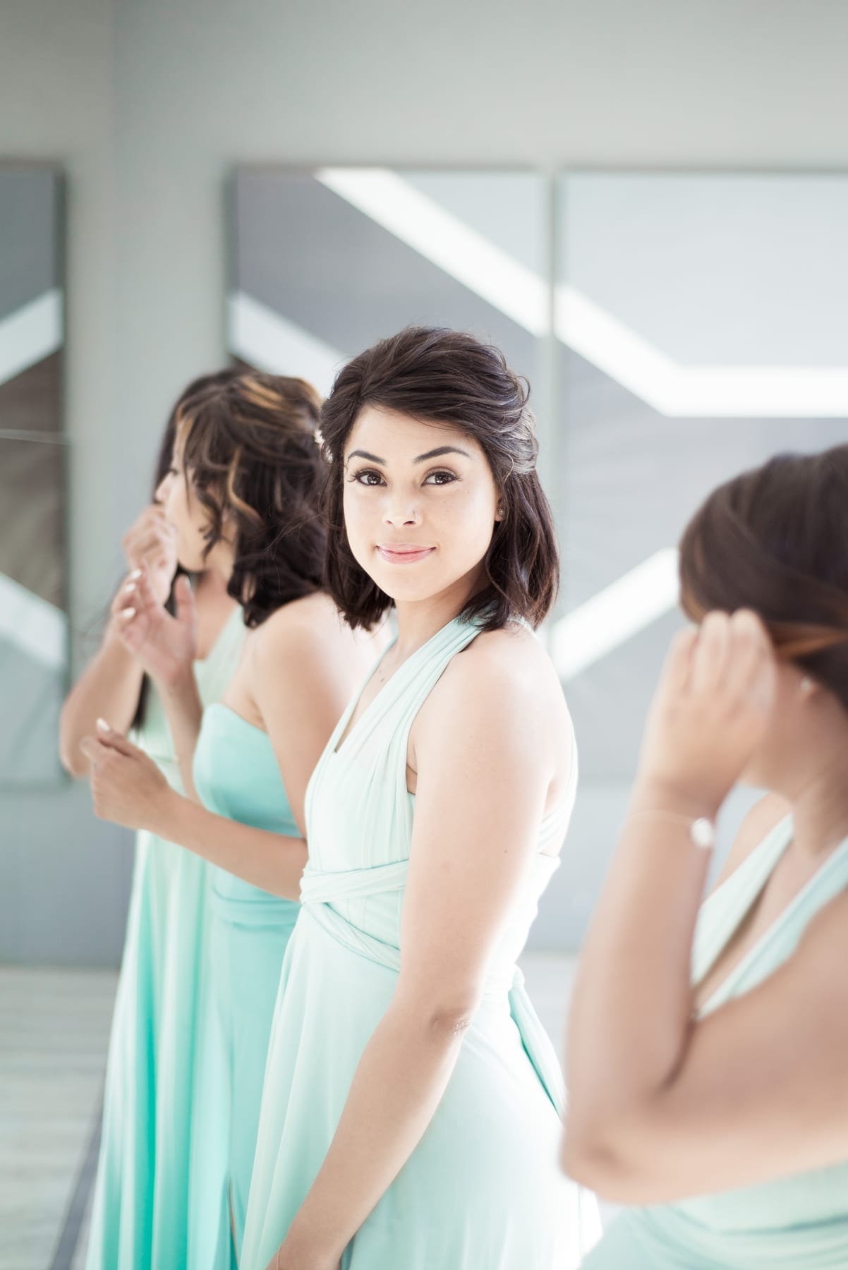 Bridesmaids in mint at the mirror