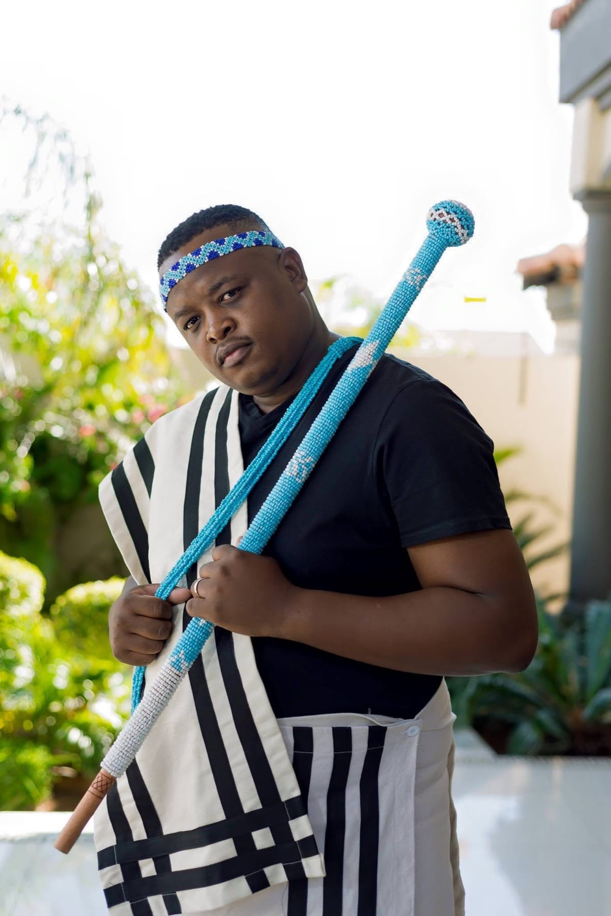 Groom with a beaded stick over his shoulder